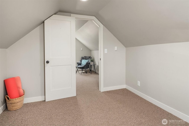bonus room featuring baseboards, carpet, and vaulted ceiling