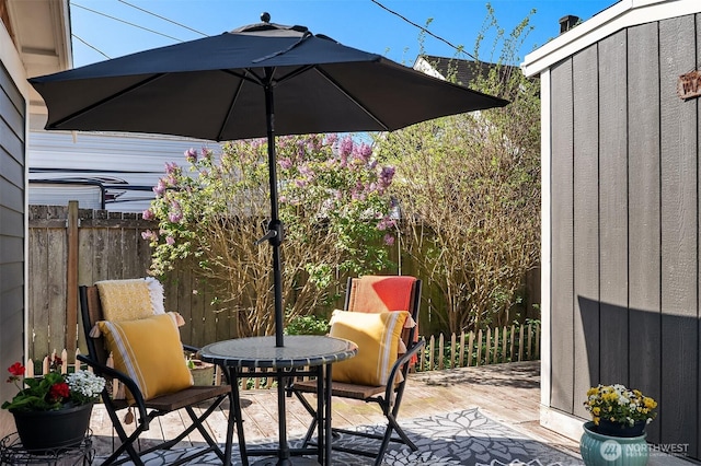 view of patio / terrace with a deck and fence