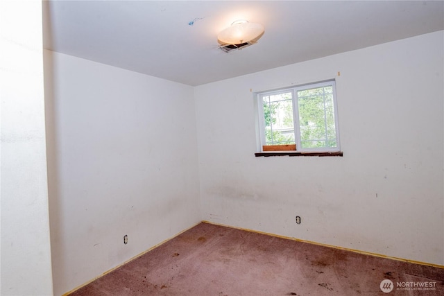 carpeted empty room with baseboards