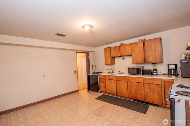 kitchen featuring dishwasher, white range with electric stovetop, visible vents, and light countertops