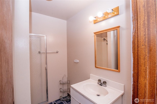 bathroom with walk in shower and vanity