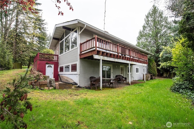 back of house featuring a yard, a patio, and a deck