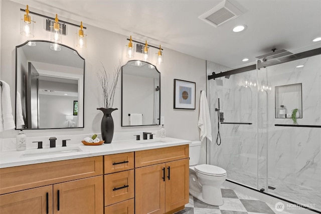 11016 46th St E, Edgewood, WA 98372 - bathroom featuring double vanity, a marble finish shower, toilet, and recessed lighting