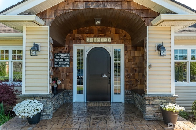 doorway to property featuring stone siding