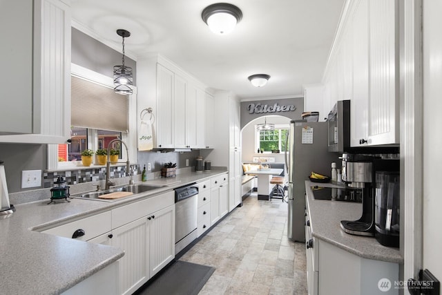 kitchen featuring crown molding, a sink, white cabinets, and stainless steel appliances
