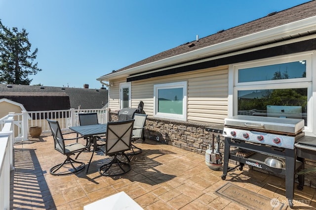view of patio featuring outdoor dining area and a grill