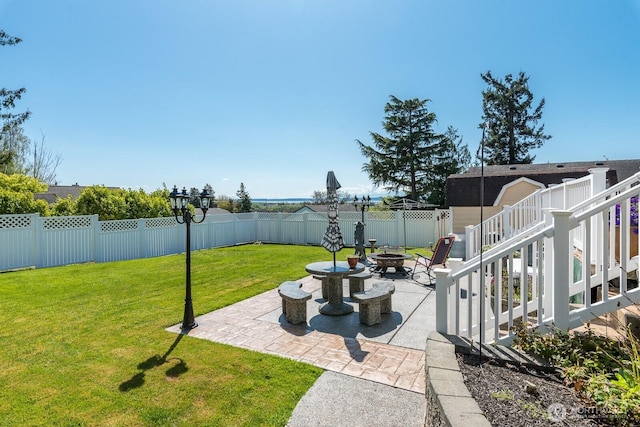 view of yard with a patio, a fire pit, and a fenced backyard