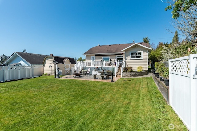 back of property with a storage unit, a fenced backyard, a patio area, a lawn, and an outdoor structure