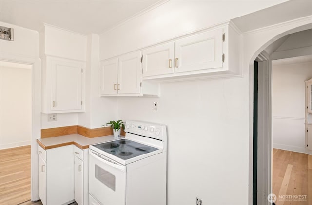 kitchen with white electric range oven, white cabinetry, light wood-style floors, light countertops, and arched walkways