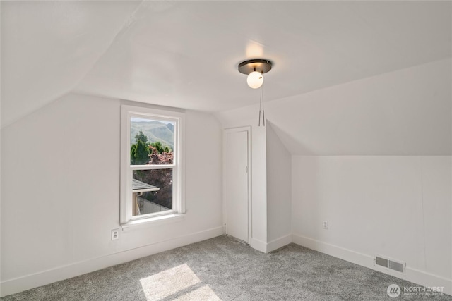 bonus room featuring visible vents, carpet floors, and vaulted ceiling