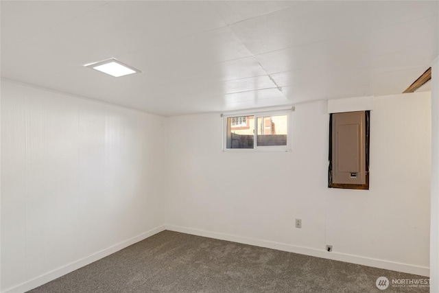 basement with dark carpet and baseboards