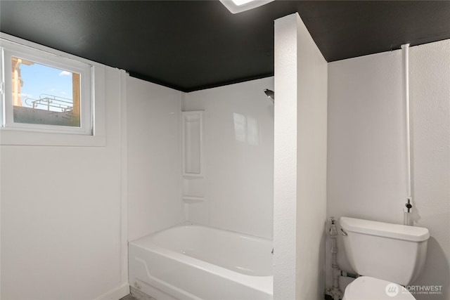 bathroom featuring toilet and tub / shower combination