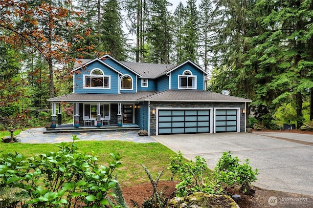 28728 NE 52nd St, Carnation, WA 98014 - view of front of home with a porch, a garage, a front lawn, concrete driveway, and stone siding