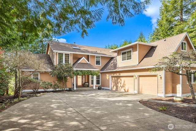 view of front facade featuring driveway, an attached garage, and roof with shingles