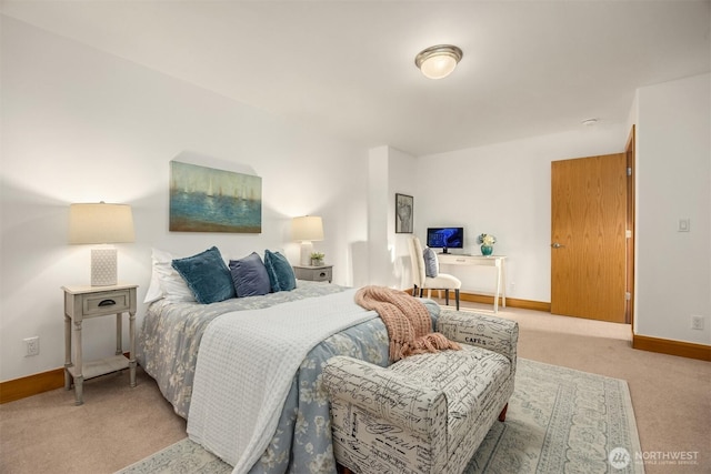bedroom featuring baseboards and light colored carpet