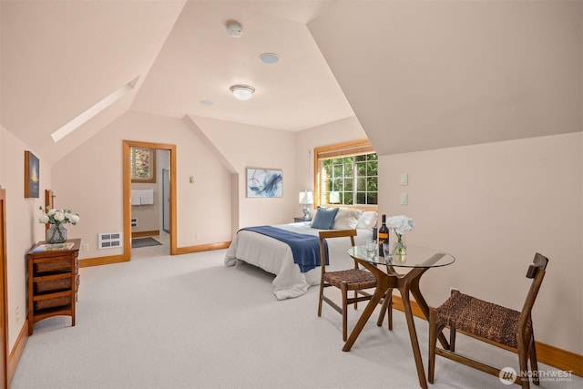 bedroom with vaulted ceiling, baseboards, light carpet, and a skylight