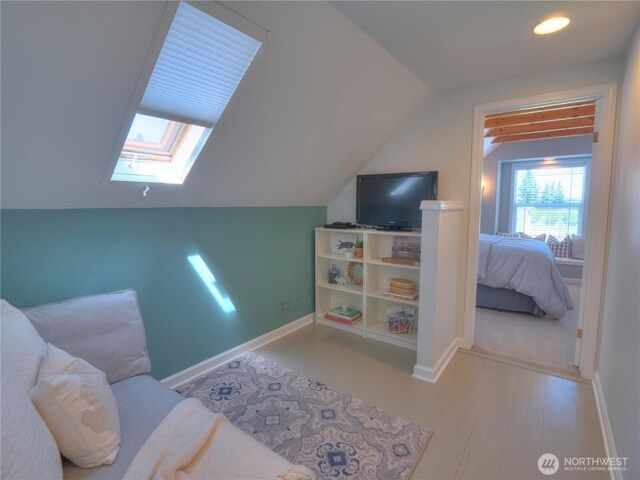 interior space with recessed lighting, baseboards, and lofted ceiling with skylight