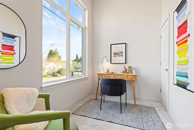 carpeted office featuring plenty of natural light and baseboards
