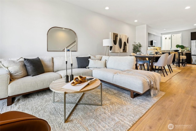 living area featuring light wood-type flooring and recessed lighting