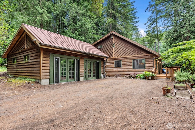 13600 Hillcrest St NW, Poulsbo, WA 98370 - back of house with a standing seam roof, a deck, french doors, and a metal roof