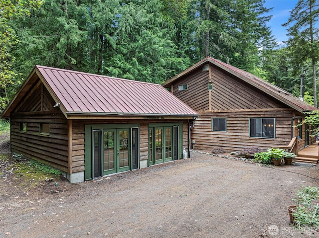 13600 Hillcrest St NW, Poulsbo, WA 98370 - back of house featuring a standing seam roof, a metal roof, and french doors