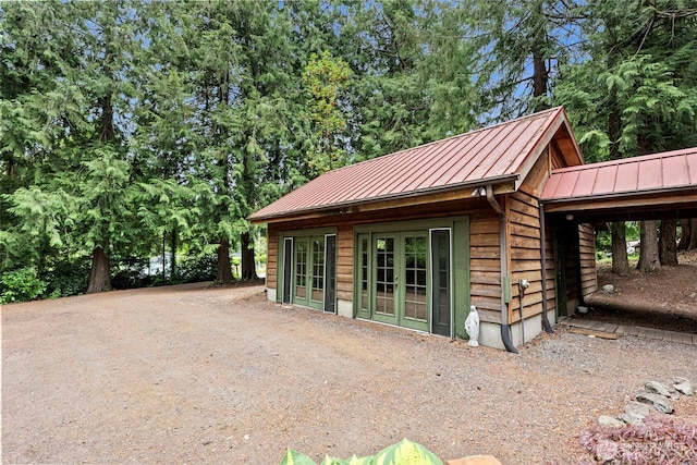 13600 Hillcrest St NW, Poulsbo, WA 98370 - view of home's exterior with a standing seam roof, french doors, and a metal roof