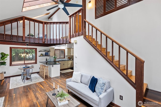 13600 Hillcrest St NW, Poulsbo, WA 98370 - living room featuring a ceiling fan, high vaulted ceiling, dark wood finished floors, stairway, and a chandelier