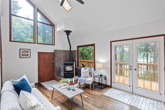 13600 Hillcrest St NW, Poulsbo, WA 98370 - living area with a wood stove, wood finished floors, ceiling fan, vaulted ceiling, and french doors