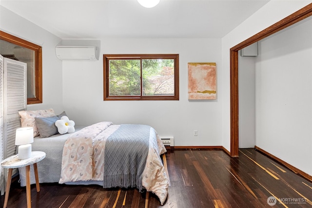13600 Hillcrest St NW, Poulsbo, WA 98370 - bedroom featuring a wall mounted air conditioner, hardwood / wood-style floors, and baseboard heating