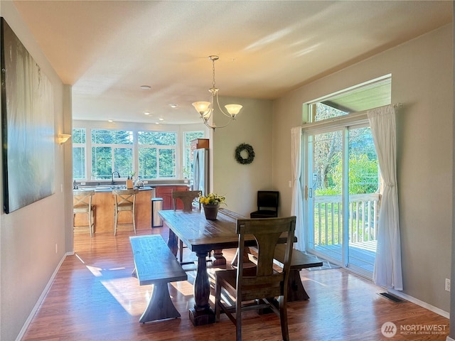 168 Jackson Rd, Orcas Island, WA 98245 - dining space featuring a chandelier, baseboards, and wood finished floors