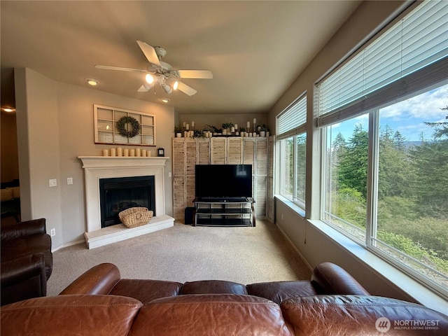 168 Jackson Rd, Orcas Island, WA 98245 - carpeted living room with ceiling fan, a fireplace with raised hearth, and baseboards