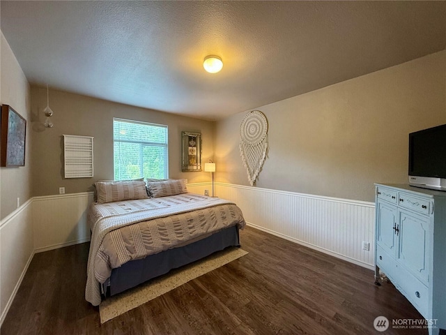 168 Jackson Rd, Orcas Island, WA 98245 - bedroom with dark wood finished floors and wainscoting