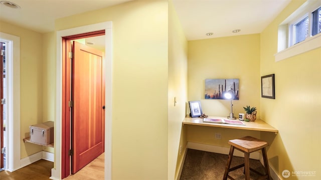 office area with wood finished floors and baseboards