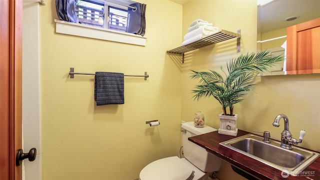 half bath featuring a sink and toilet