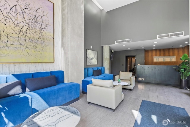 76 Cedar St Unit Ph07, Seattle, WA 98121 - community lobby with a towering ceiling, wood walls, and recessed lighting