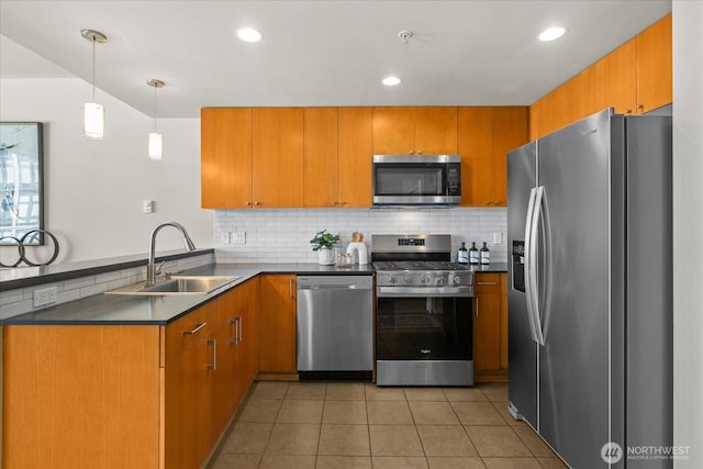 76 Cedar St Unit Ph07, Seattle, WA 98121 - kitchen featuring stainless steel appliances, a peninsula, dark countertops, decorative backsplash, and light tile patterned floors