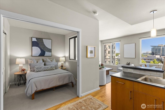 76 Cedar St Unit Ph07, Seattle, WA 98121 - bedroom with a sink and light wood-style floors