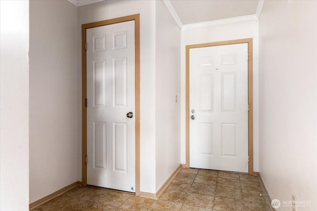 doorway with crown molding and baseboards