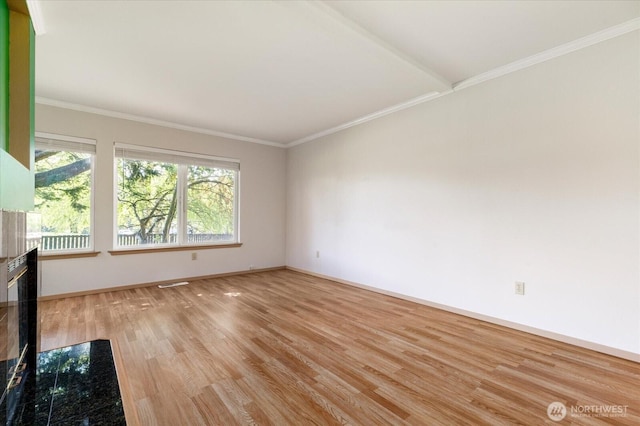 unfurnished living room featuring wood finished floors, crown molding, visible vents, and baseboards