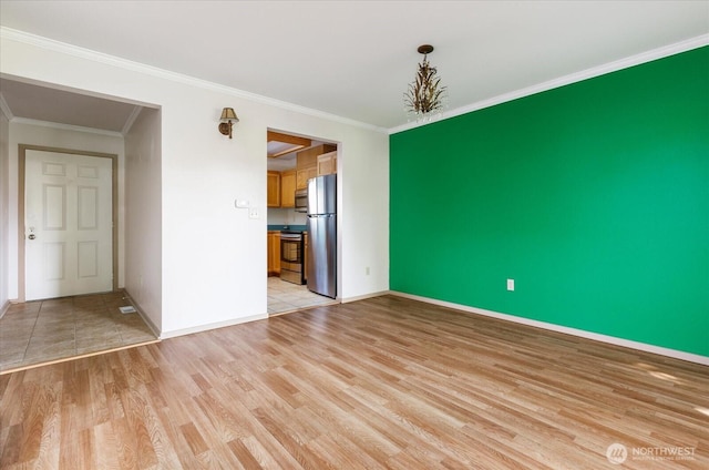 interior space featuring ornamental molding, light wood finished floors, and baseboards