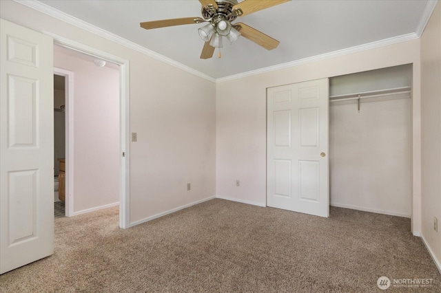 unfurnished bedroom with baseboards, crown molding, a closet, and carpet