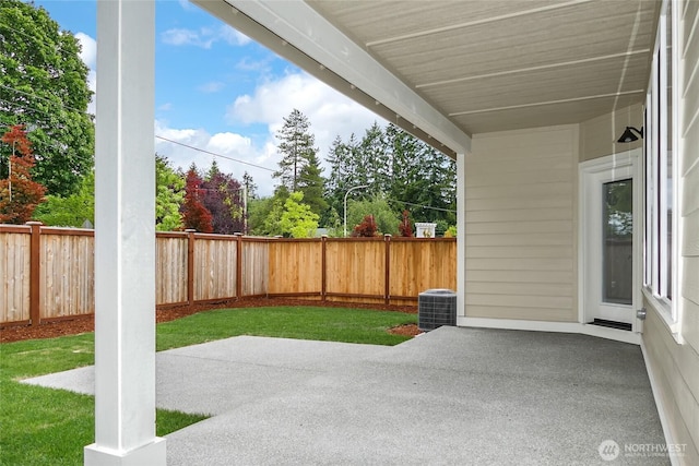 view of patio with a fenced backyard and central AC unit