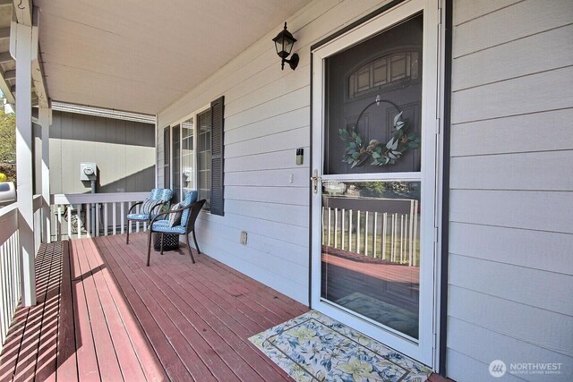 wooden terrace featuring covered porch