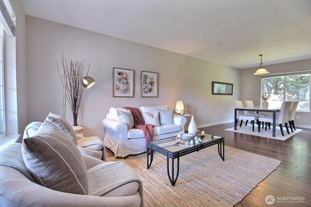 living room featuring baseboards and wood finished floors