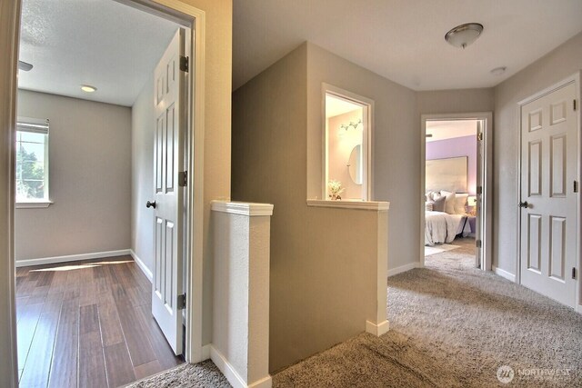 hall with wood finished floors and baseboards