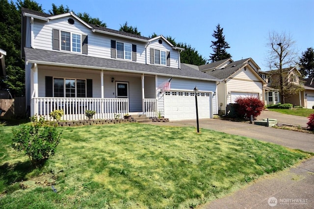 traditional-style house with concrete driveway, an attached garage, a front lawn, and covered porch