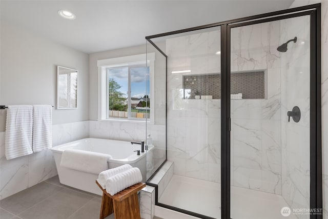 20018 7th Ave SE, Bothell, WA 98012 - bathroom featuring tile patterned flooring, a freestanding tub, tile walls, recessed lighting, and a marble finish shower