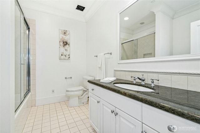 bathroom featuring toilet, bath / shower combo with glass door, ornamental molding, tile patterned flooring, and vanity