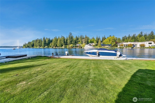dock area with a water view and a lawn