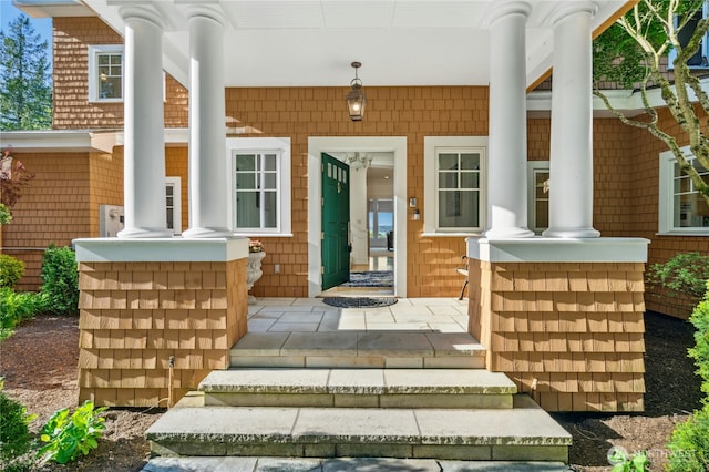 view of exterior entry with a porch